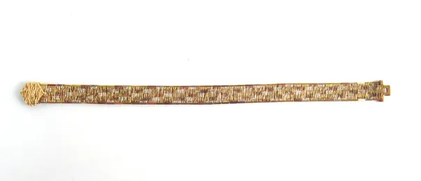 A 9ct three colour gold bracelet, in a bark textured brick link design, with a foldover clasp, engraved with a presentation inscription, Birmingham 19