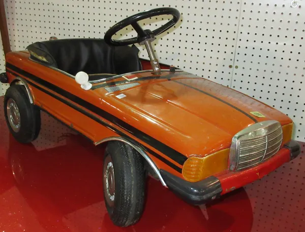 Toys, including; a 20th century red painted tin pedal car, 92cm wide. B5