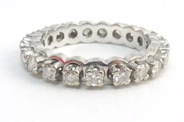 A white gold and diamond set full eternity ring, claw set with circular cut diamonds, in a raised design, ring size J.