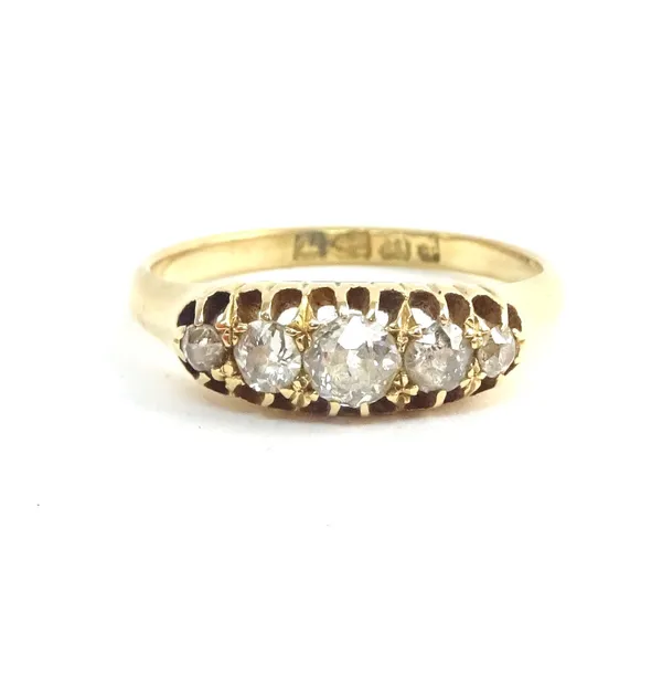 An 18ct gold and diamond five stone ring, mounted with a row of cushion shaped diamonds graduating in size to the centre stone, ring size L and a half