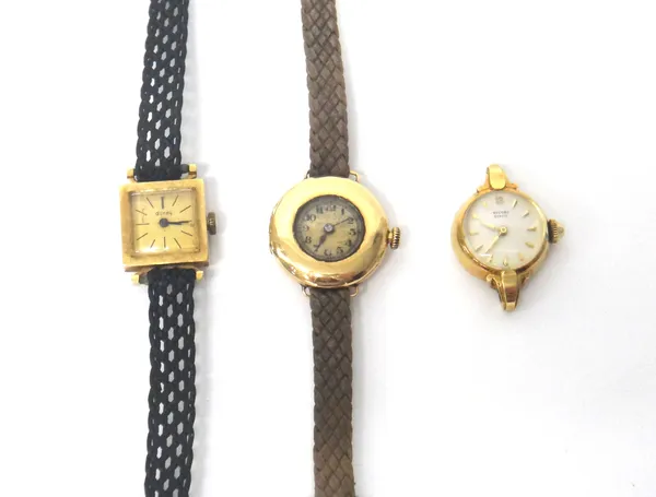 A gold circular cased lady's wristwatch, detailed within the caseback 18 K 0,750, on a textile strap, a Record Geneve gold circular cased lady's wrist