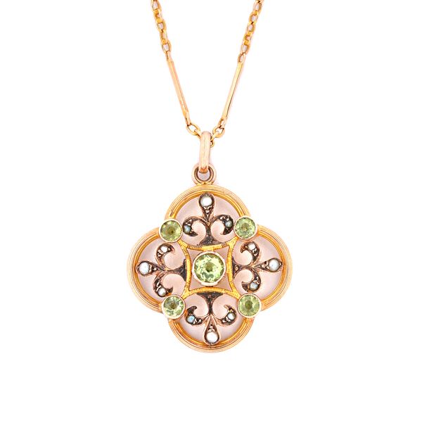 A gold, peridot and seed pearl set pendant, circa 1910, in a pierced quatrefoil shaped design with a gold bar and oval link neckchain, (2). Illustrate