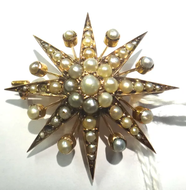 A gold and seed pearl set brooch, designed as an eight pointed starburst, circa 1900.