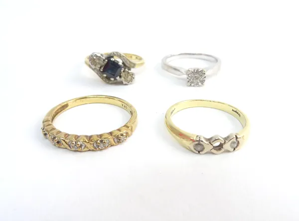 An 18ct gold and platinum sapphire and diamond set three stone ring, in a crossover design, a 9ct white gold and diamond set seven stone cluster ring,