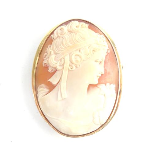 A gold mounted oval shell cameo brooch, carved as the portrait of a lady, her hair tied with a ribbon, detailed 585.