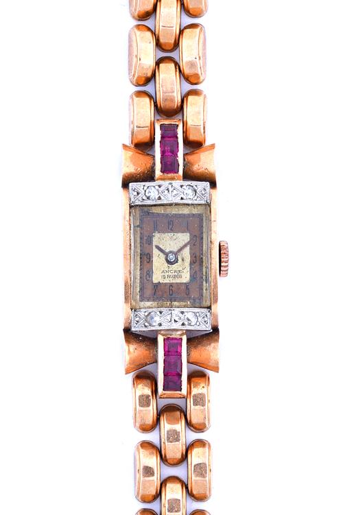 A lady's gold, diamond and synthetic ruby set dress bracelet wristwatch, circa 1940, the two tone rectangular dial detailed Ancre 15 rubis, the case m