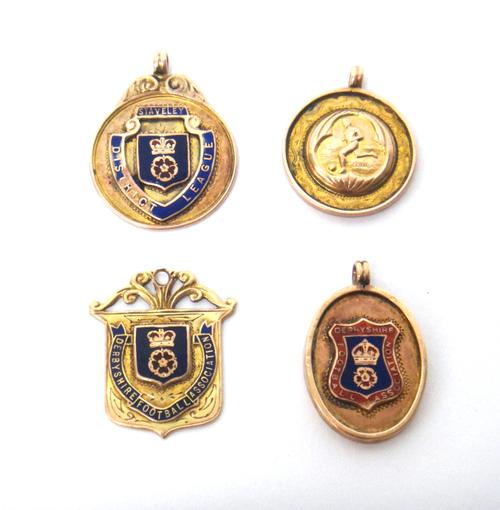 Two 9ct gold and enamelled Derbyshire Football Association fob medals, a 9ct gold and enamelled Staveley District League fob medal and a 9ct gold Stav