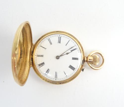 A lady's gold cased, keyless wind, hunting cased fob watch, with an unsigned gilt jewelled cylinder movement, the enamelled dial with black Roman nume