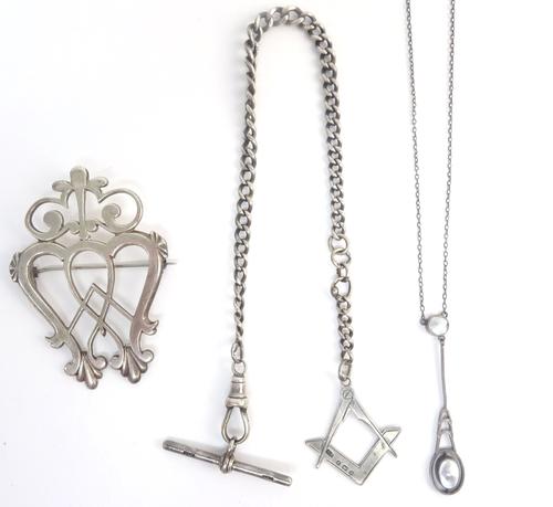 A Scottish silver brooch, in a pierced design, circa 1820, a silver curb link watch Albert chain, fitted with a T bar, a swivel and with a square and