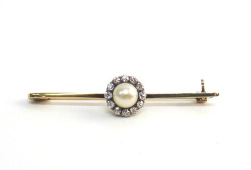 A gold, diamond and cultured pearl bar brooch, mounted with a single cultured pearl to the centre, in a surround of cushion shaped diamonds, on a plai