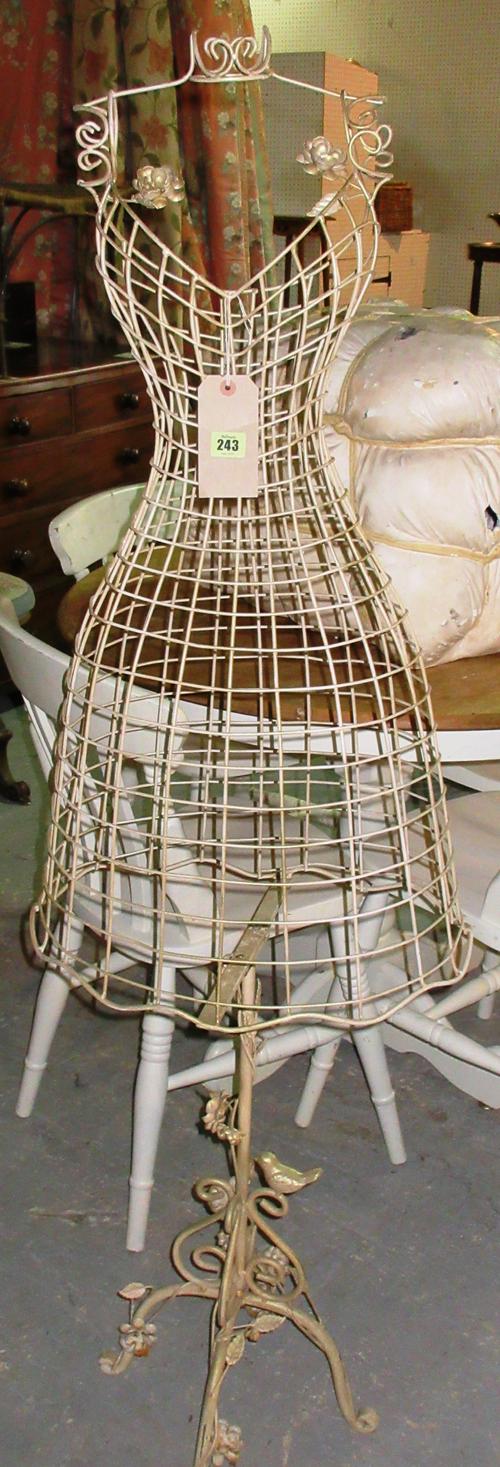 A gold painted wirework metal mannequin with crown finial, the base decorated with vine leaves and a bird 151cm high. G6