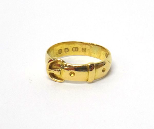 A Victorian 18ct gold ring, in a buckle and strap design, London 1878, ring size L and a half, weight 3.7 gms.