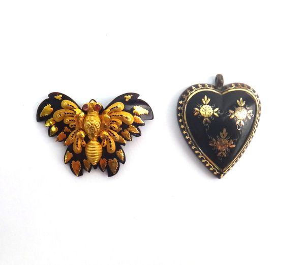 A gold mounted tortoiseshell brooch, designed as a butterfly, with cabochon red gem set eyes and a pique tortoiseshell pendant, designed as a heart, (