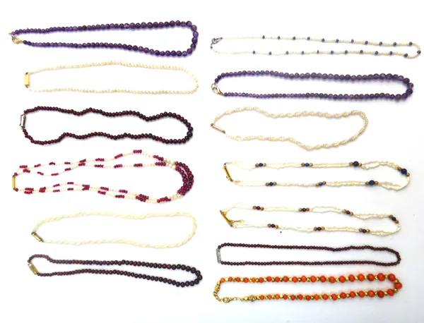Two single row necklaces of amethyst quartz beads, three single row necklaces of garnet beads, a single row necklace of seed pearls interspersed with