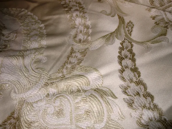 Curtains, comprising; a pair of lined gold curtains with inset darker swag decoration, 140cm wide x 215cm fall.  G6