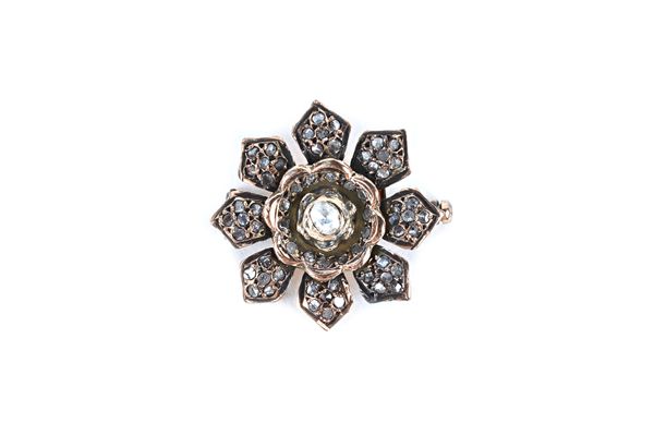 A rose diamond brooch, designed as a flowerhead, mounted with the principal rose diamond to the flowerhead centre, diameter 2.8cm. Illustrated