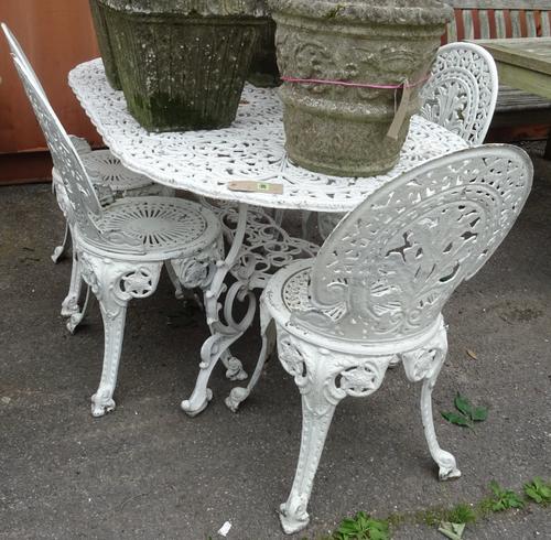 A 20th century white painted metal oval table with six chairs, 162cm wide, (7). OUT