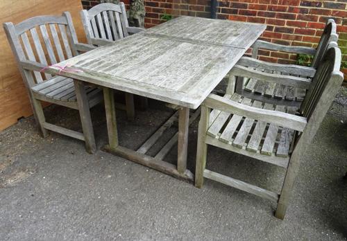 A 20th century rectangular teak garden table and four chairs, 180cm wide, (5).  OUT
