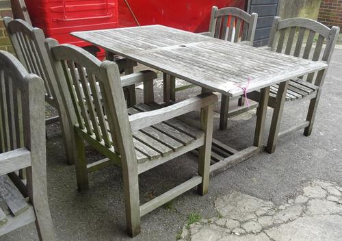 A 20th century rectangular teak garden table and four chairs, 178cm wide, (5).  OUT