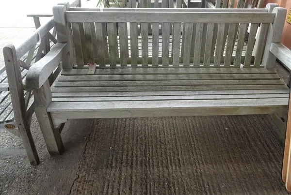 A similar pair of teak slatted garden benches, 185cm wide, (2). OUT