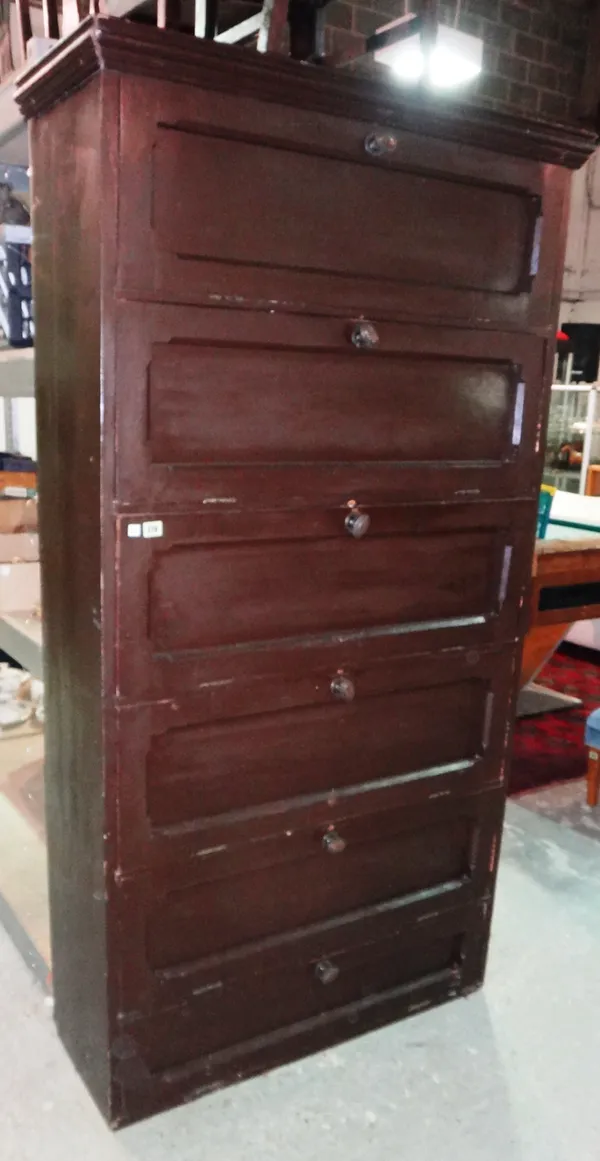 An early 20th century stained pine linen cabinet with six drop down doors, 104cm wide.   G4