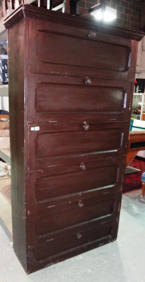 An early 20th century stained pine linen cabinet with six drop down doors, 104cm wide.   G4