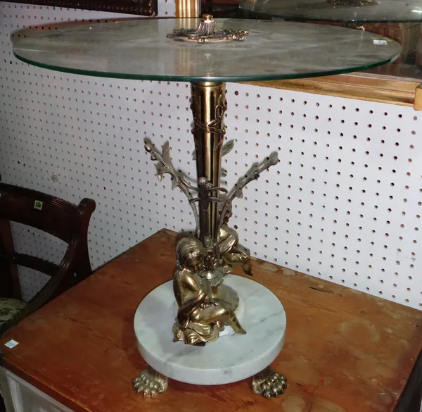 A 20th century glass and brass coffee table, the base formed as two cherubs, on claw feet, 52cm wide x 52cm high, together with a similar standing lam
