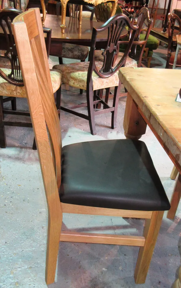 A set of six 20th century oak stick back dining chairs, with black leather seats, (6).   C8