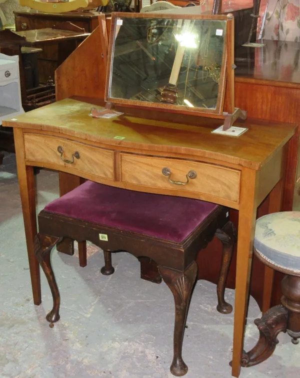 An early 20th century mahogany serpentine side table, with two short drawers on tapering square supports, 91cm wide x 76cm high, and an Edwardian swin
