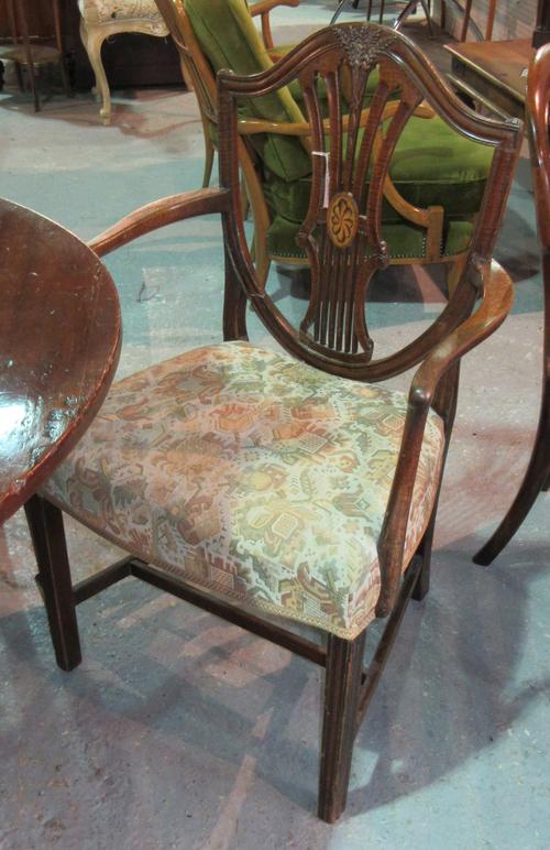 A set of seven George III style mahogany shield and pierced splat dining chairs, to include one carver, (7  D6