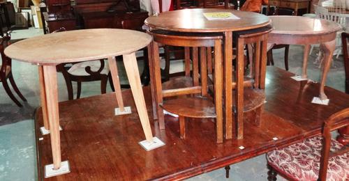 A 20th century oak circular nest of six tables, and two other 20th century oak circular side tables, 55cm wide x 48cm high, (3). H7