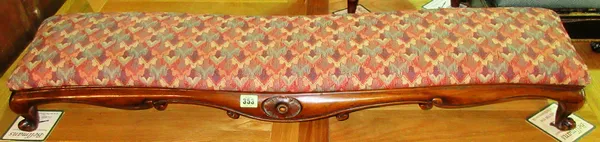 A Victorian walnut serpentine rectangular footstool, on scroll supports, 104cm wide x 18cm high, and a Victorian ebonised square footstool, 28cm wide