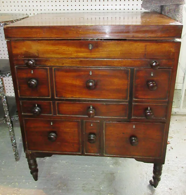 An early Victorian mahogany gentleman's washstand, with fitted interior and an arrangement of drawers, on ring turned tapering supports (a.f), 70cm wi