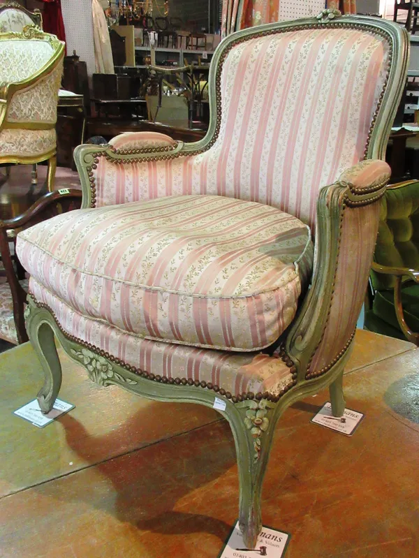 A Louis XV style green painted floral upholstered fauteuil and a small upholstered foot stall, (2).  C6