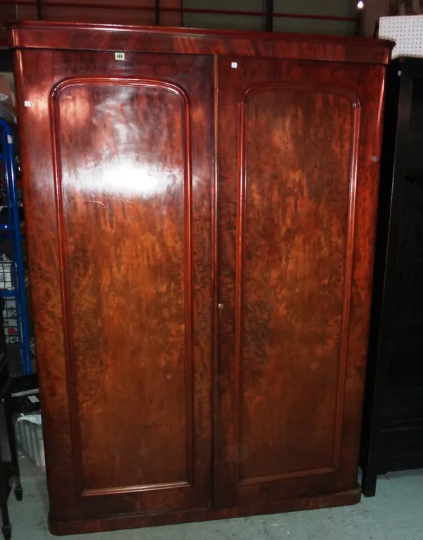 A Victorian mahogany two door wardrobe with arched panelled doors, 140cm wide x 194cm high.  M7