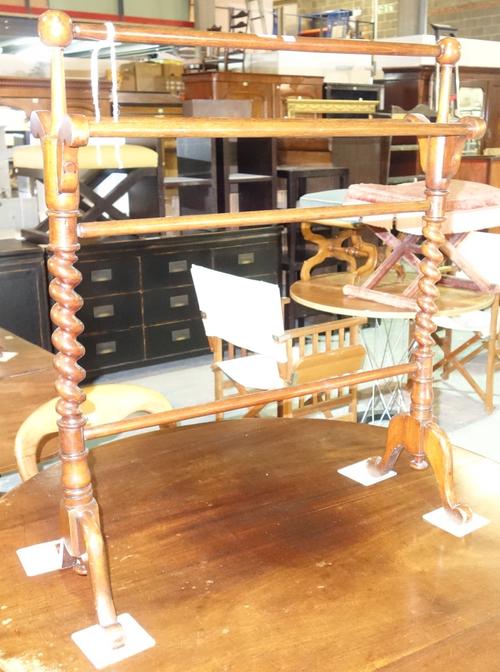 A Victorian mahogany towel rail, with twisted columns on downswept supports, 73cm wide x 69cm high, and a teak and rattan lift top trunk, 82cm wide x