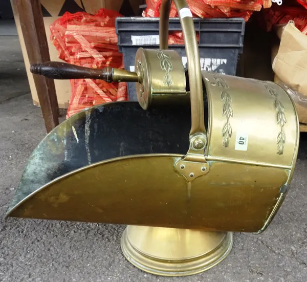 A gilt metal helmet shaped coal scuttle with swing over handle. I5