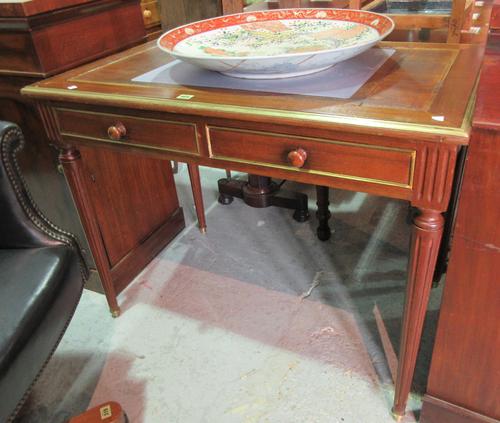An Empire style mahogany writing table, with leather inset top and brass edges, on fluted tapering supports, 100cm wide x 76cm high.  B8