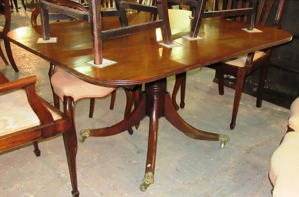 A Regency mahogany breakfast table, on four outswept supports, bold brass cappings and castors, 105cm wide x 76cm high.  F7
