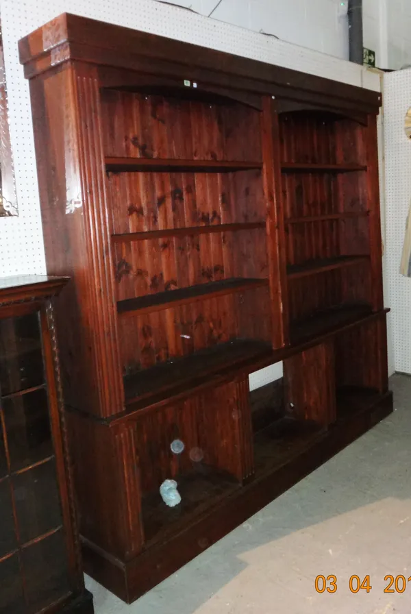 A 20th century large stained pine open bookcase, with fluted edges, open base, 223cm wide x 210cm high. K9