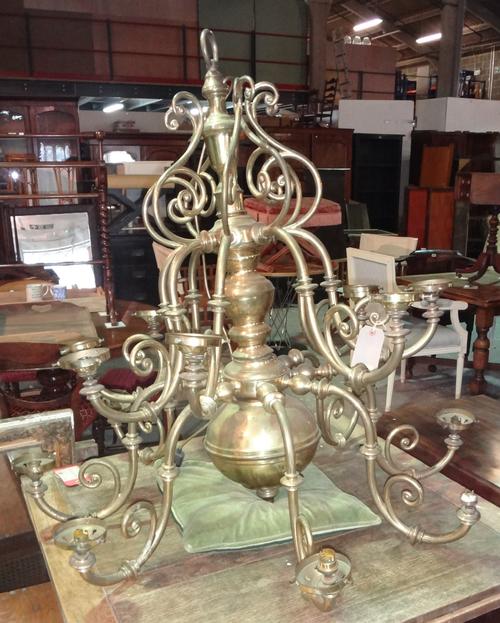 An early 20th century brass Dutch style sixteen branch hanging chandelier, 99cm high.  H8