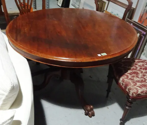A Victorian mahogany circular tilt top dining table on claw feet, 105cm wide x 75cm high and a pair of chairs, (3).  BAY1
