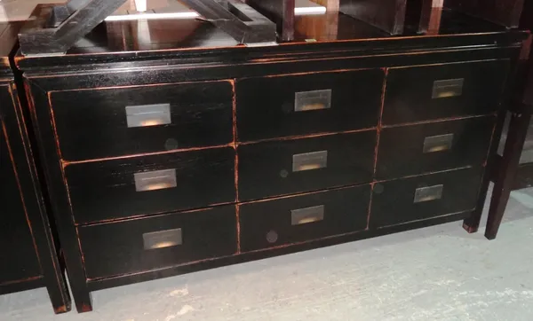 LOMBOK; A 20th century black painted ash sideboard of six drawers and one long drawer on black supports. K7