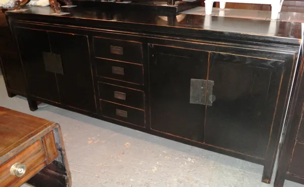 LOMBOK; A 20th century black painted hardwood sideboard, with four short drawers capped by two door cupboard, 200cm wide x 86cm high.  K8