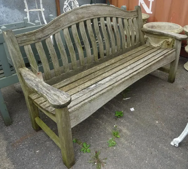 A 20th century hardwood hump-back garden bench, 160cm wide x 85cm high.  OUT