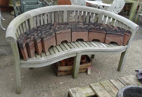 A 20th century hardwood curved back garden bench, stamped Swan, 170cm wide x 85cm high. OUT