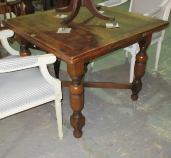 An early 20th century oak extending dining table, on turned tapering supports, united by 'X' frame stretcher, 91cm wide x 71cm high x 151cm fully exte