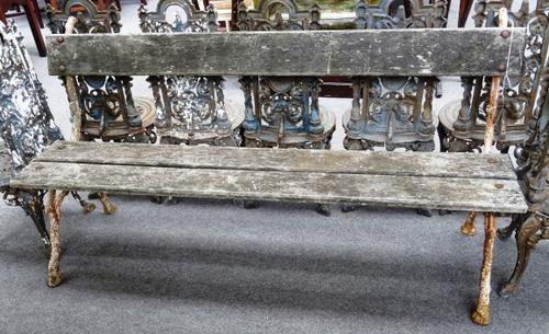 A 19th century garden bench, with wooden plank back and seat, on white painted cast iron naturalistic supports, 167cm wide x 88cm high.  OUT