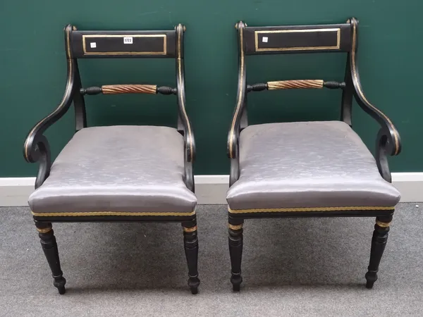 A pair of ebonised parcel gilt open armchairs in the Regency design, on turned supports, 53cm wide x 83cm high, (2).  I4