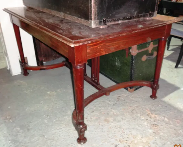 A 20th century Empire style mahogany centre table, on ring turned tapering supports united by stretcher, 138cm wide x 75cm high.   I5